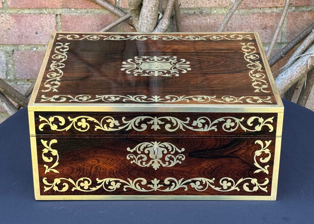 Front view of an view of an Antique Jewellery Box in Rosewood with Scrollwork Brass Inlay.