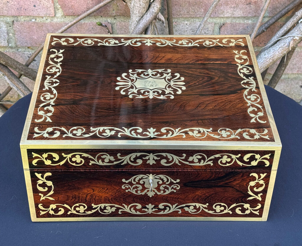 Overhead view of an Antique Jewellery Box in Rosewood with Scrollwork Brass Inlay.