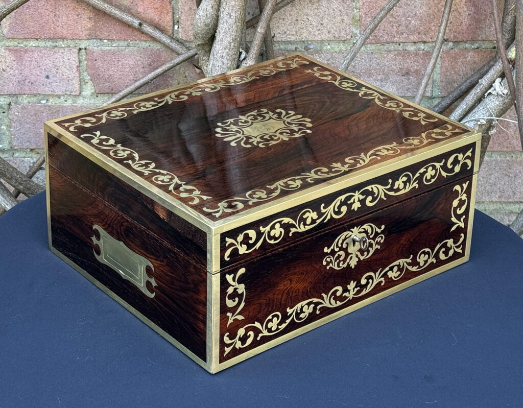 Front left view of an Antique Jewellery Box in Rosewood with Scrollwork Brass Inlay.
