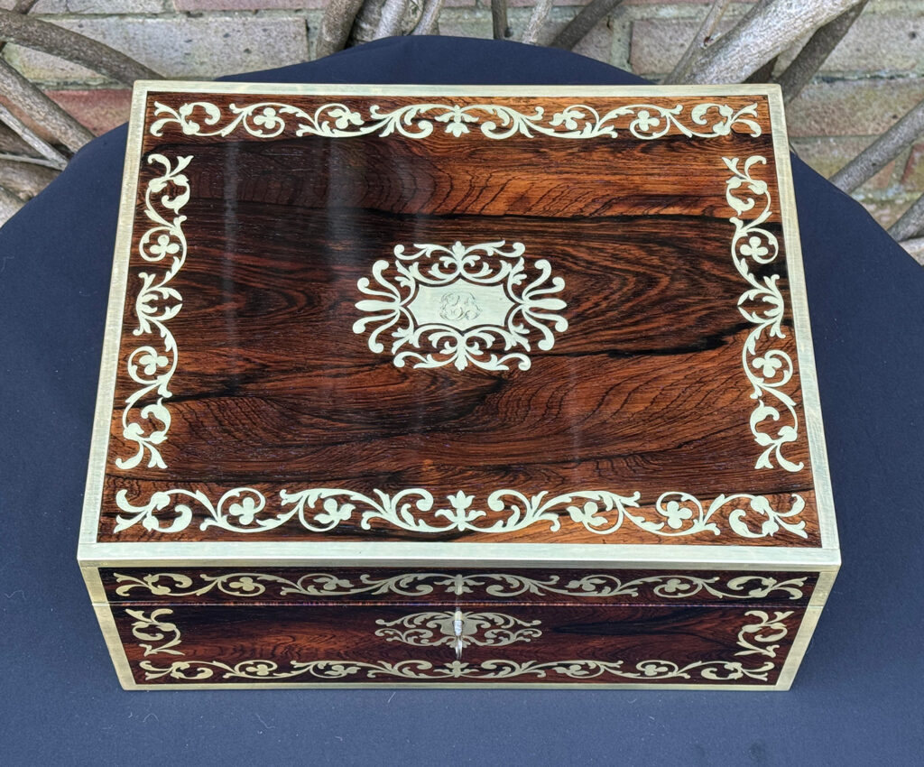 Overhead view of an Antique Jewellery Box in Rosewood with Scrollwork Brass Inlay.