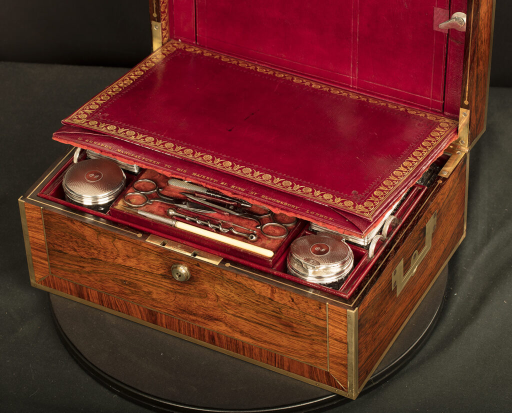 Close up interior view of an Antique Silver Mounted Dressing Case in Rosewood, by David Edwards with concealed letter wallet on display.