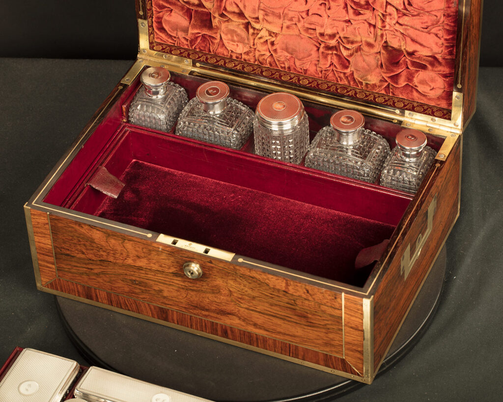 Close up interior view of an Antique Silver Mounted Dressing Case in Rosewood, by David Edwards with tray removed.