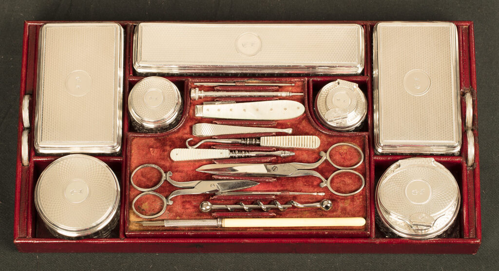 Close up view of the top tray containing silver mounted jars from an Antique Silver Mounted Dressing Case in Rosewood, by David Edwards.