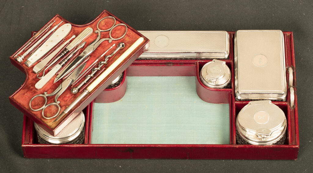 Top tray containing silver mounted jars from an Antique Silver Mounted Dressing Case in Rosewood, by David Edwards with vanity tool tray removed.