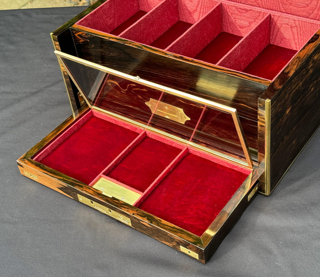 Close up internal view of an Antique Jewellery Box with Secret Internal Travelling Box and Glass Display Area with hinged glass lid open.