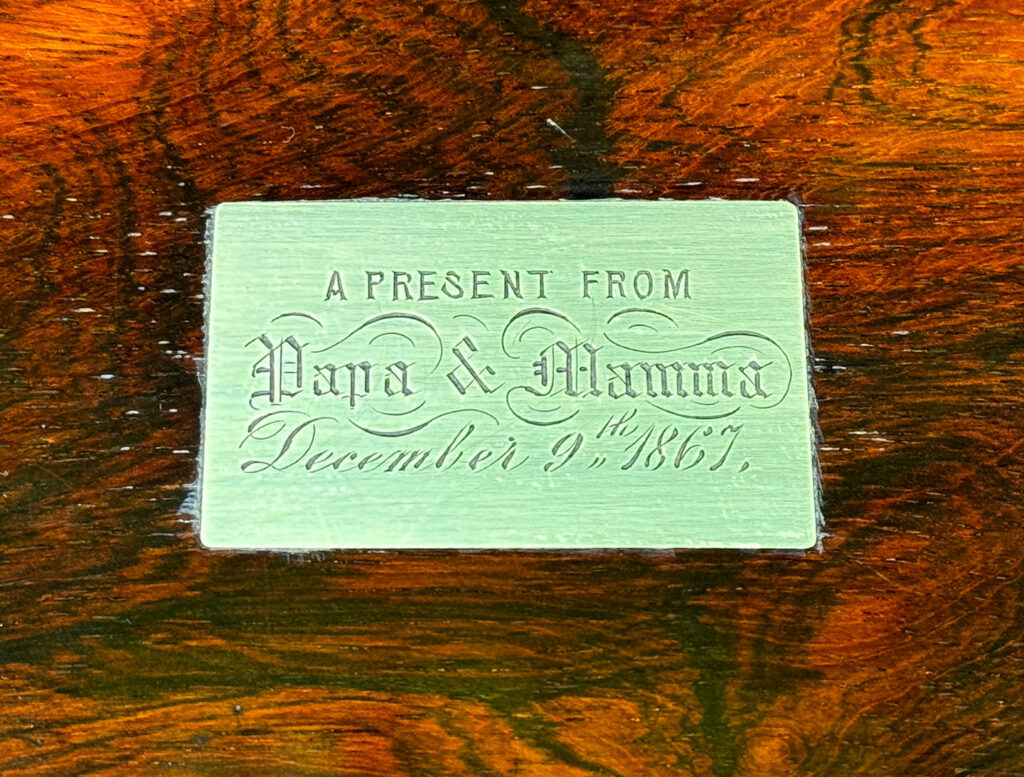 Close up of the engraved brass plaque from an Antique Jewellery Box in Rosewood.