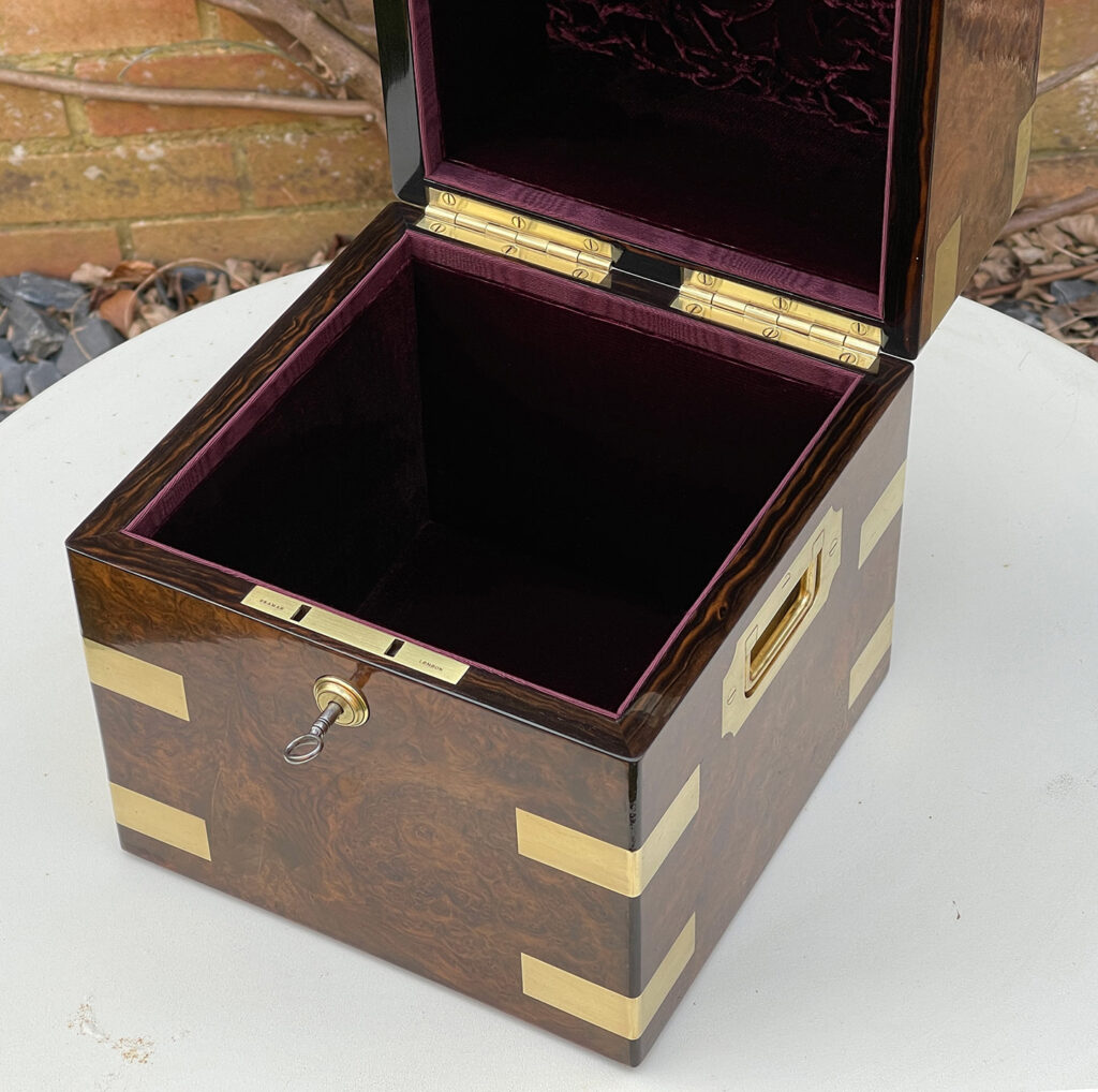 Close up interior view of an Antique Jewellery Box in Burr Walnut.