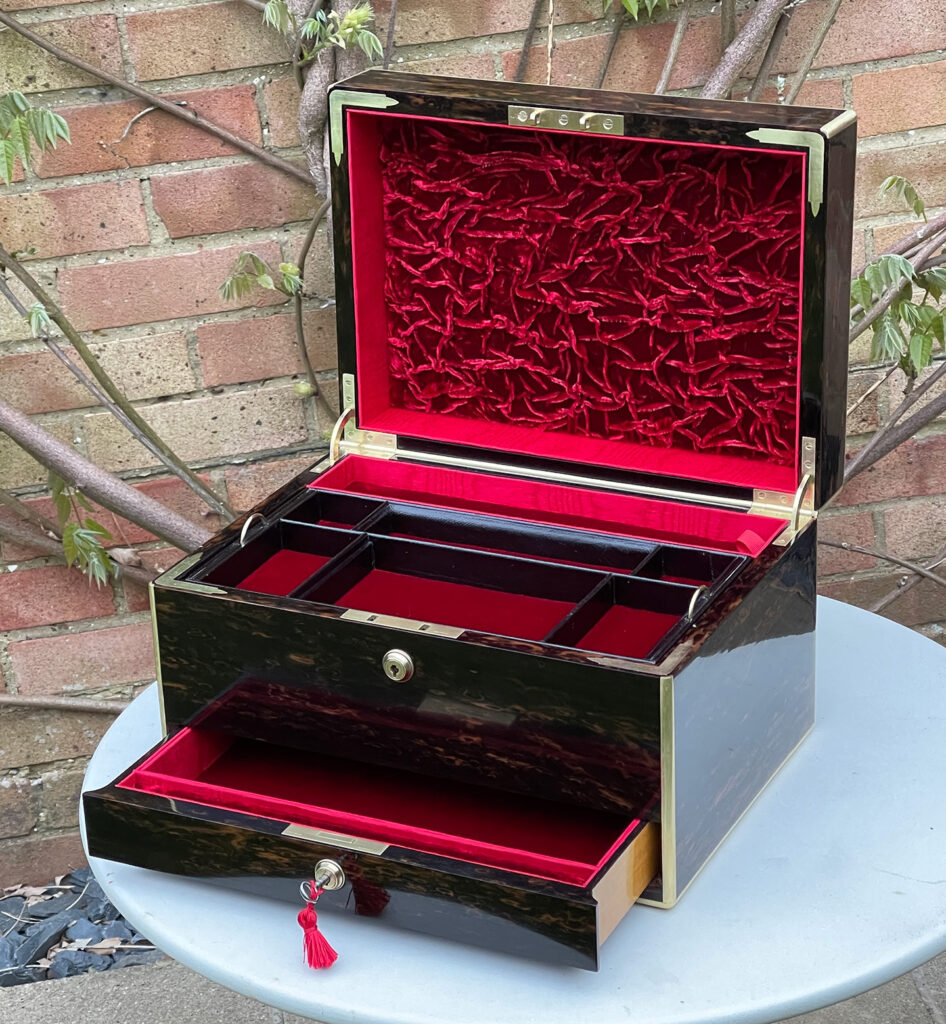 Front right internal view of an Antique Jewellery Box in Coromandel with lower drawer open.