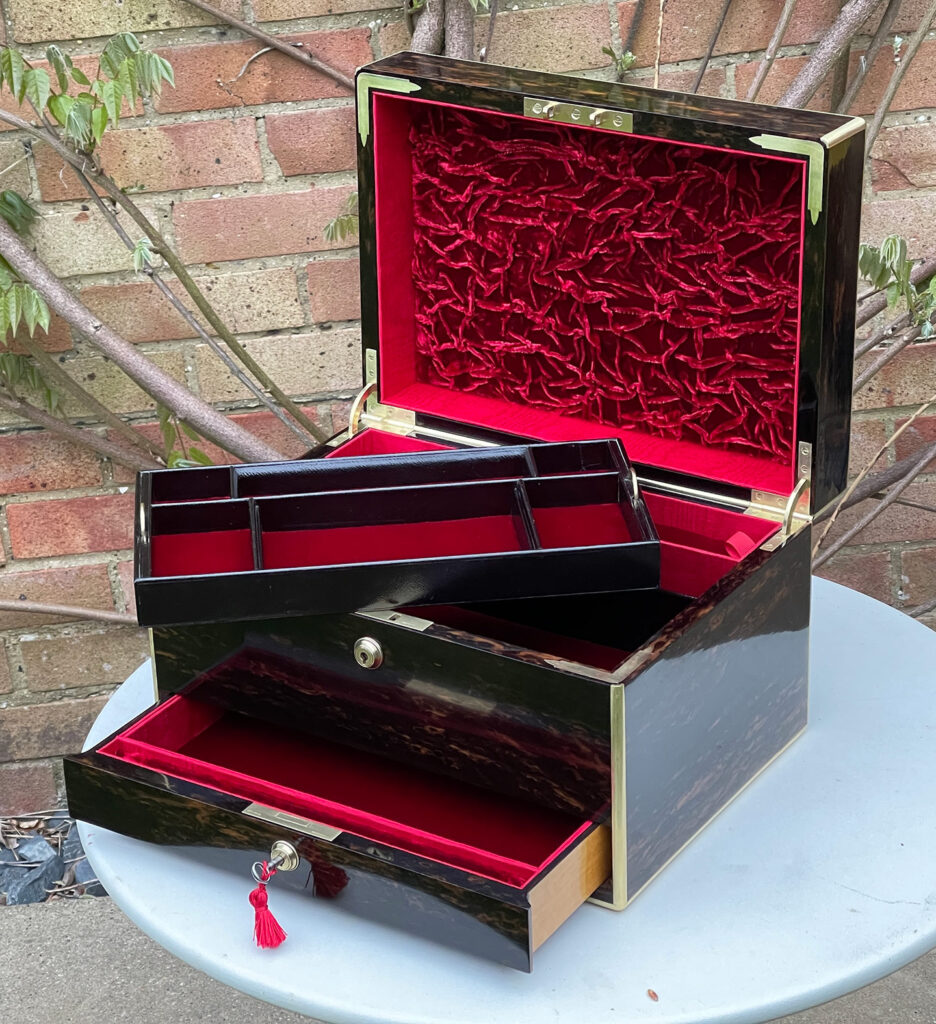Front right internal view of an Antique Jewellery Box in Coromandel with lower drawer open and tray removed.