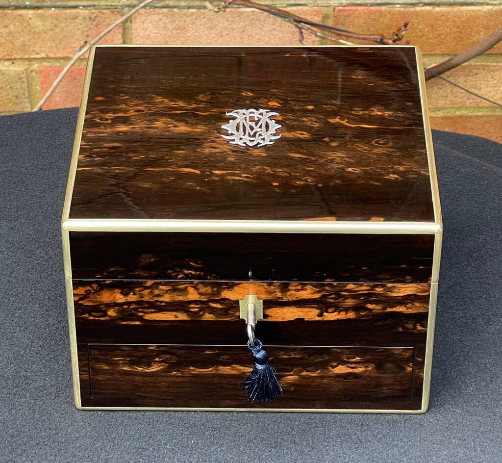 Overhead view of a Miniature Antique Dressing Case in Coromandel, by Betjemann and Sons.