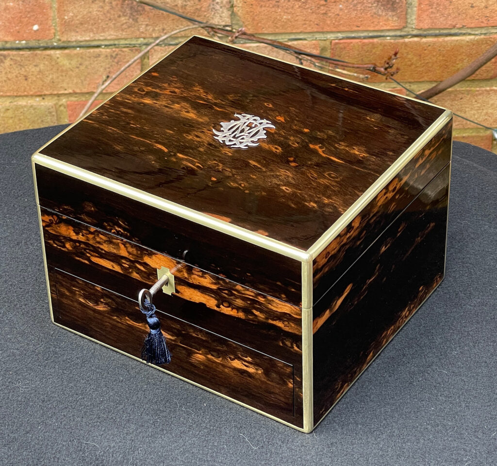 Front right overhead view of a Miniature Antique Dressing Case in Coromandel, by Betjemann and Sons.