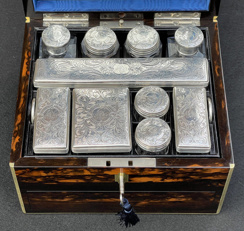 Silver mounted bottles from a Miniature Antique Dressing Case in Coromandel, by Betjemann and Sons.