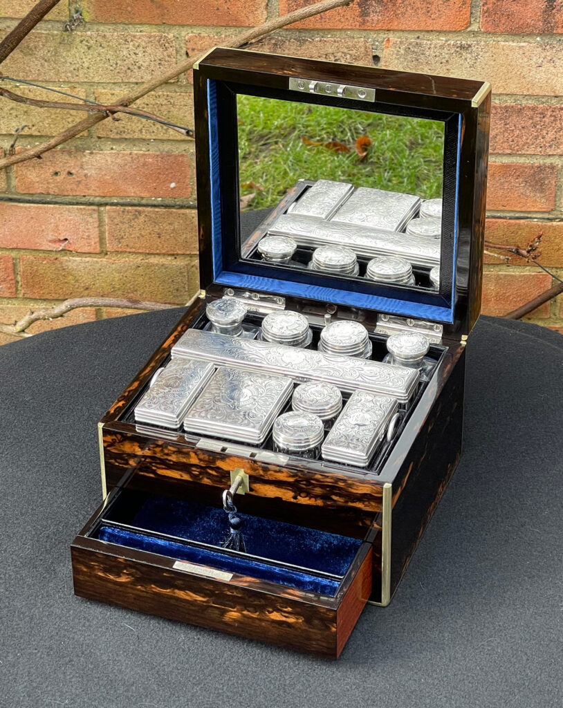 Front right internal view of a Miniature Antique Dressing Case in Coromandel, by Betjemann and Sons with lower drawer open.