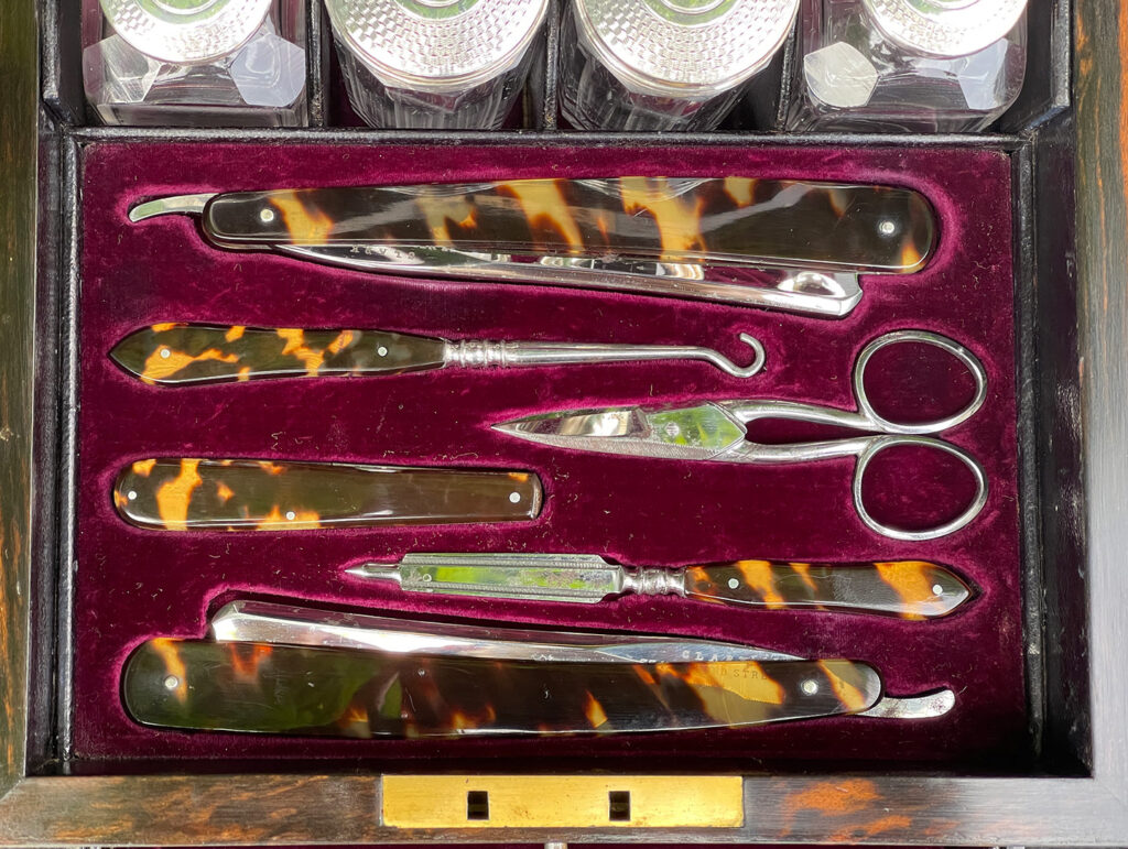 Close up view of the vanity tool tray from a Miniature Antique Gentleman’s Dressing Case in Calamander.