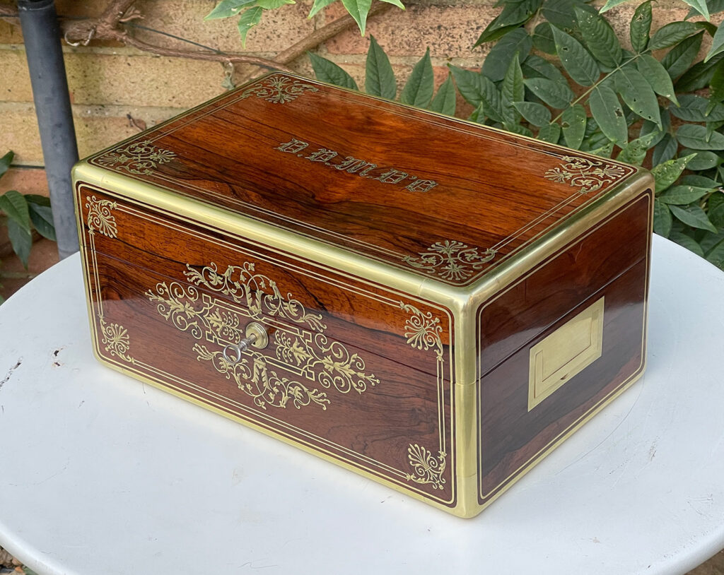 Front right view of a French Antique Jewellery Box in Rosewood with Delicate Brass Inlay, by Aucoc Ainé.