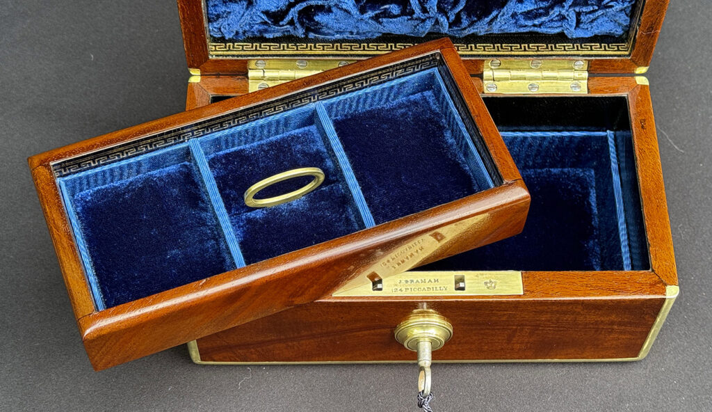 Close up internal view of a Miniature Antique Jewellery Box in Solid Mahogany with tray removed.