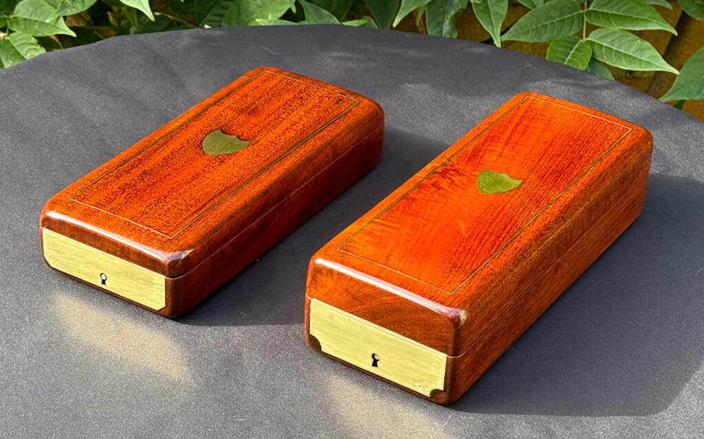 Front right angled view of a Pair of Small French Antique Solid Mahogany Jewellery Boxes.