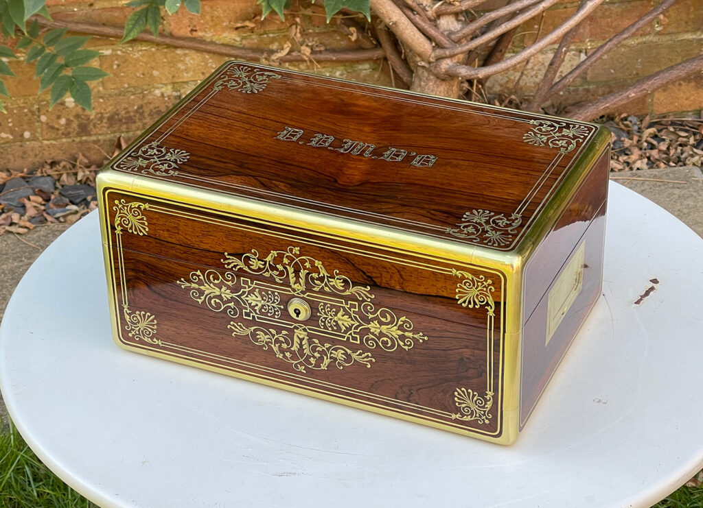 Front angled view of a French Antique Jewellery Box in Rosewood with Delicate Brass Inlay, by Aucoc Ainé.