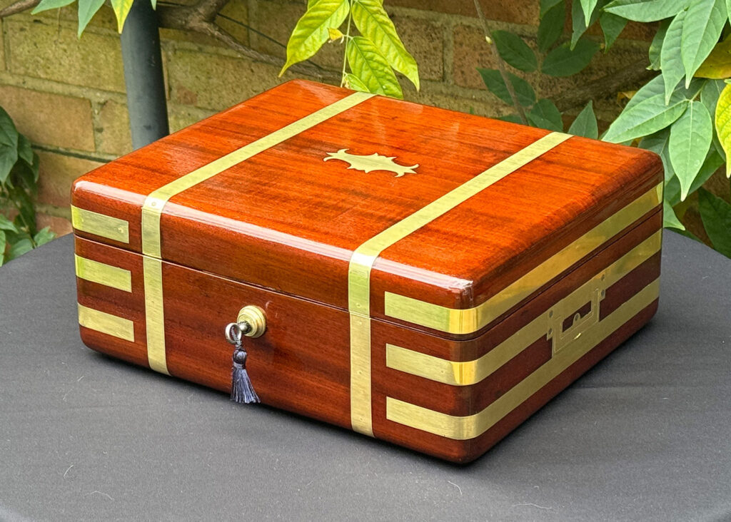 Front right view of an Antique Radial Edged Travelling Jewellery Box in Mahogany.