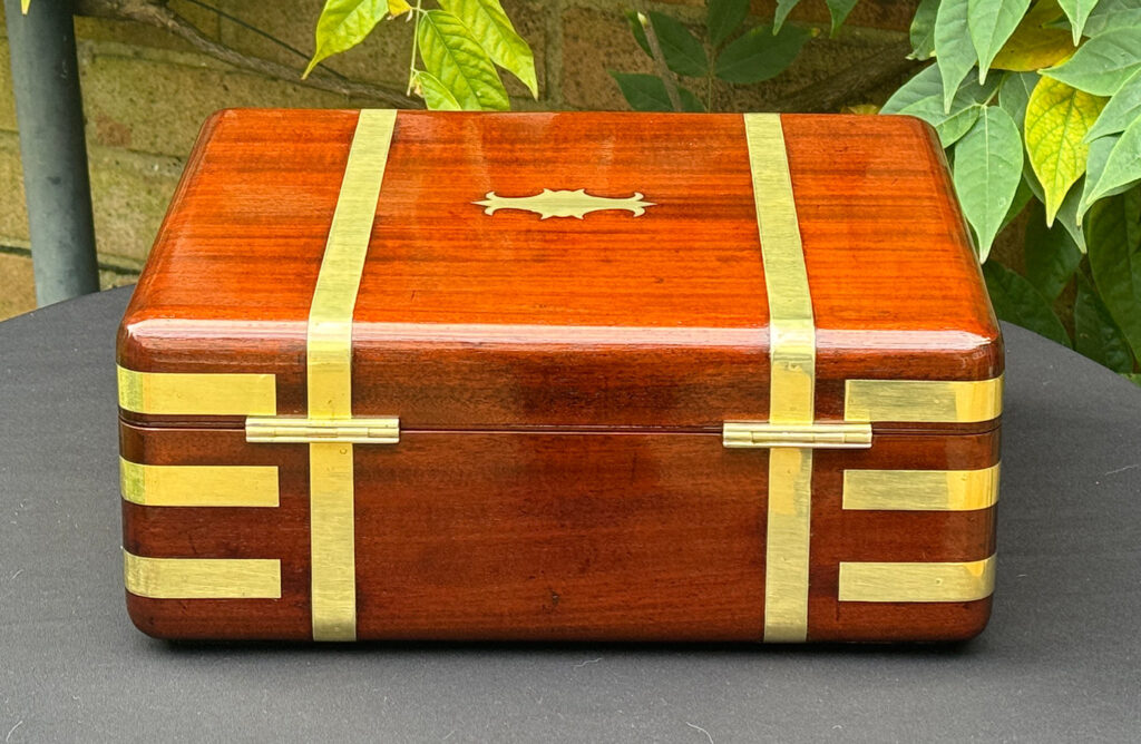 Rear view of an Antique Radial Edged Travelling Jewellery Box in Mahogany.