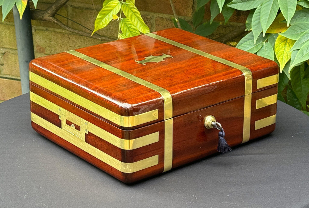 Front left view of an Antique Radial Edged Travelling Jewellery Box in Mahogany.