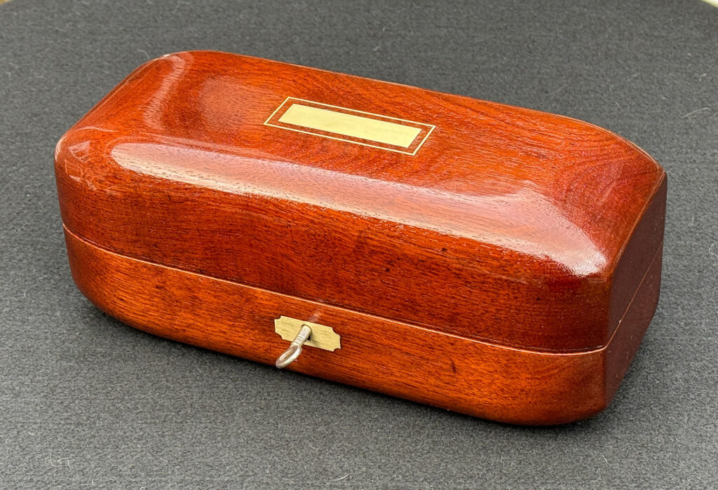 Overhead view of an Antique Radial Edged Jewellery Box in Cuban Mahogany.