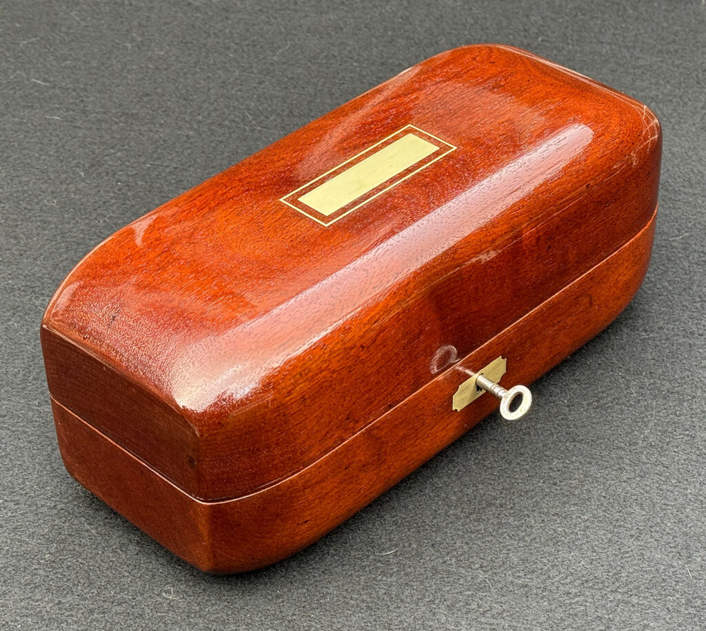 Front left view of an Antique Radial Edged Jewellery Box in Cuban Mahogany.