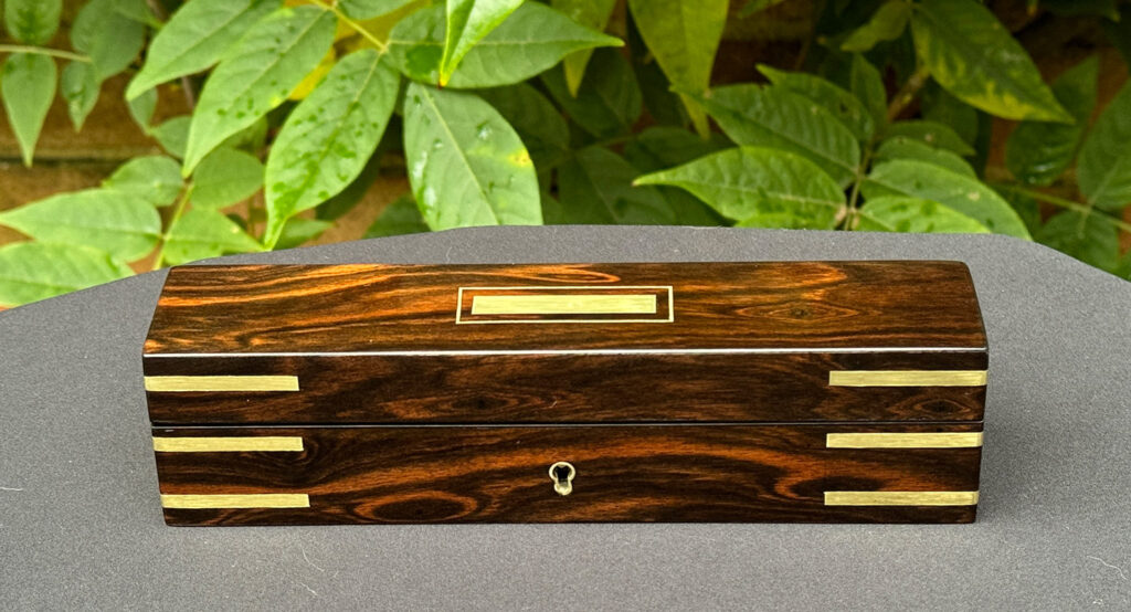 Front view of an Antique Miniature Pocket Jewellery Box in Calamander.