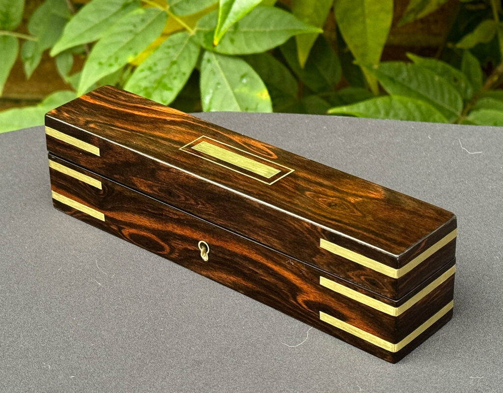 Front right view of an Antique Miniature Pocket Jewellery Box in Calamander.
