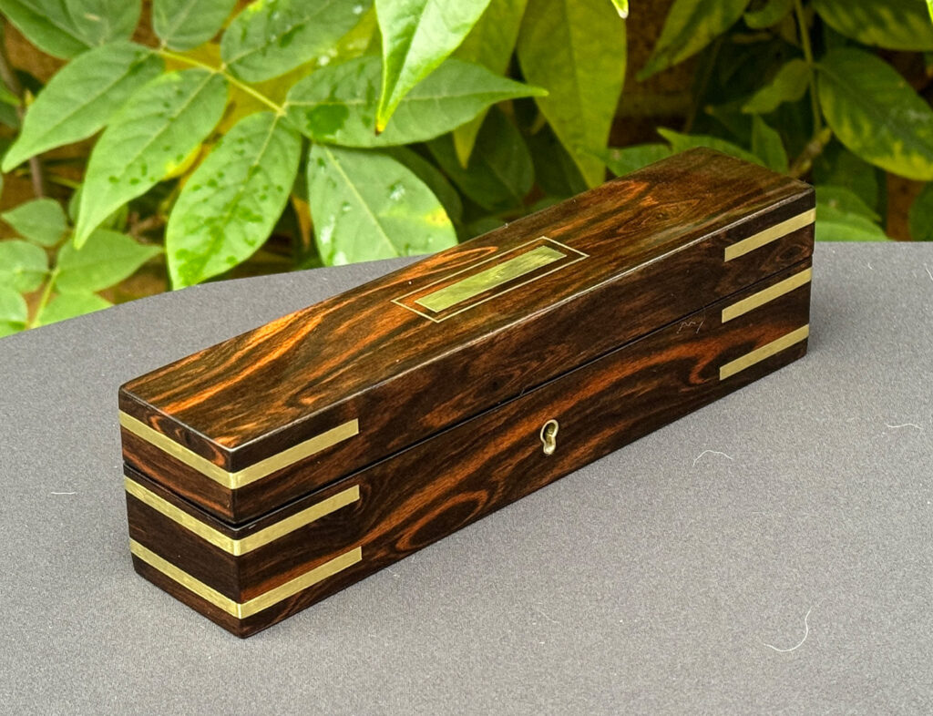Front left view of an Antique Miniature Pocket Jewellery Box in Calamander.