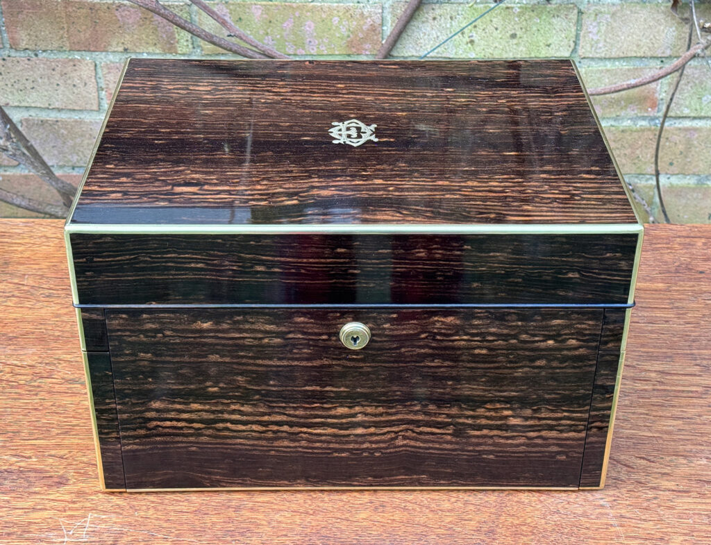 Overhead view of an Antique Jewellery Box in Coromandel with Betjemann Patent Automatic Mechanism, by Fisher.
