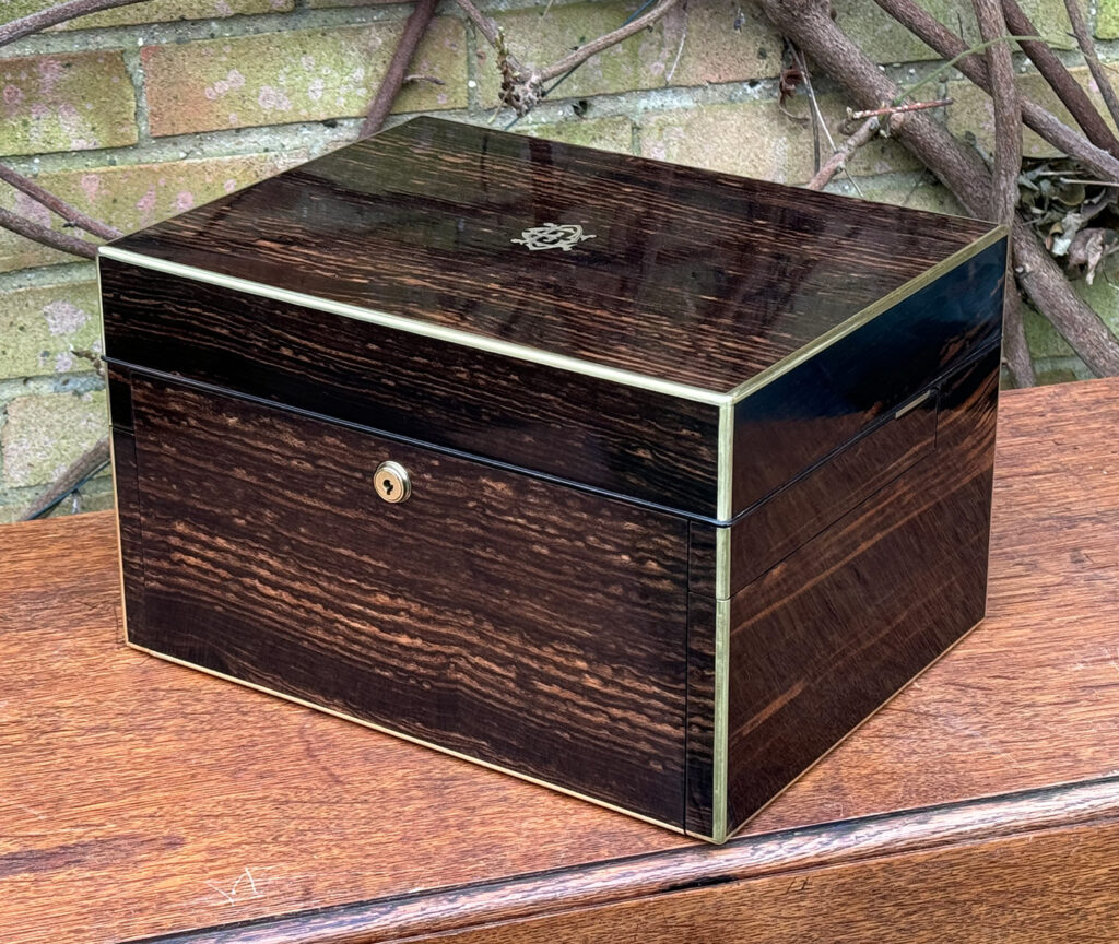 Front right view of an Antique Jewellery Box in Coromandel with Betjemann Patent Automatic Mechanism, by Fisher.