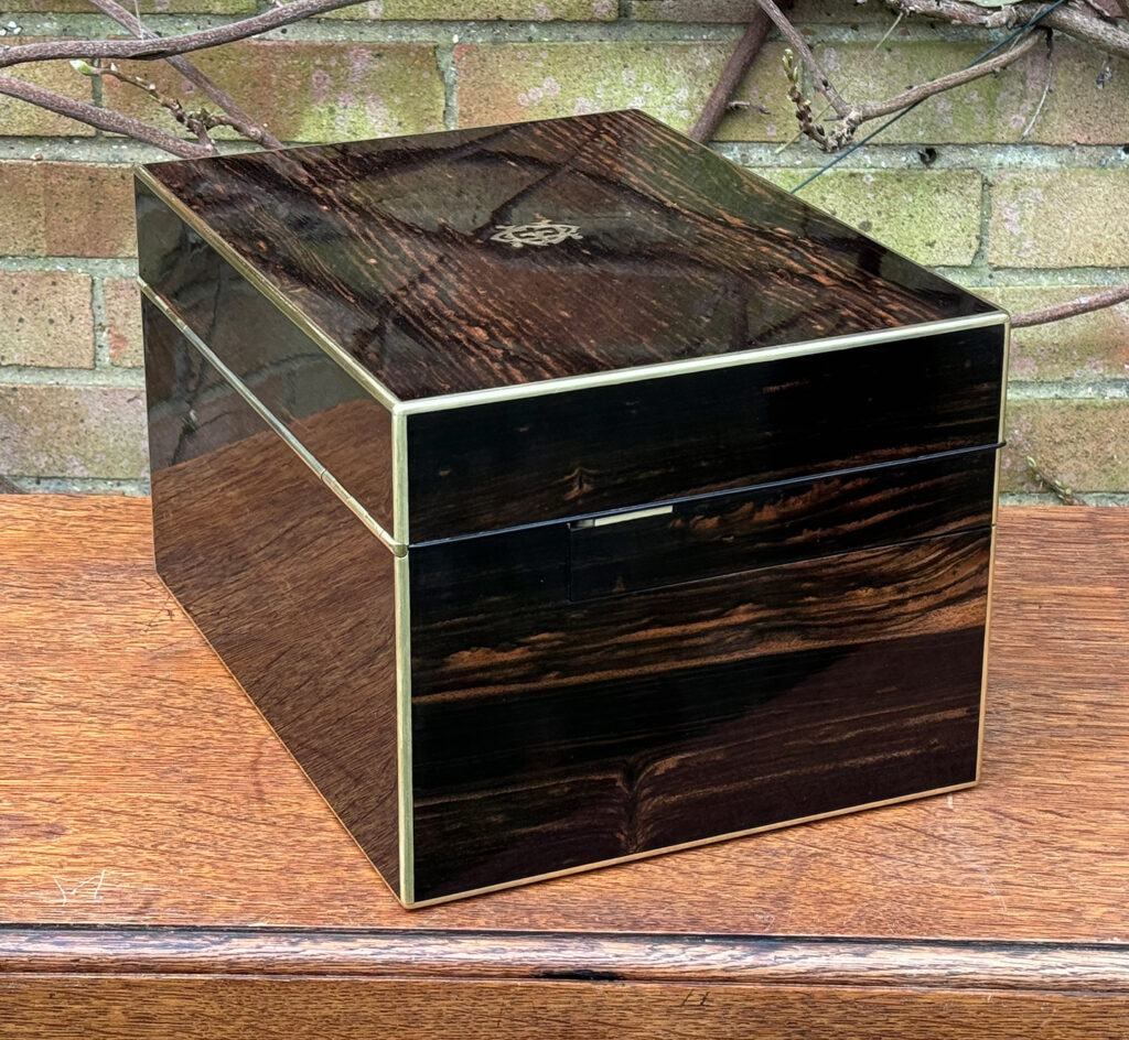 Left side view of an Antique Jewellery Box in Coromandel with Betjemann Patent Automatic Mechanism, by Fisher.