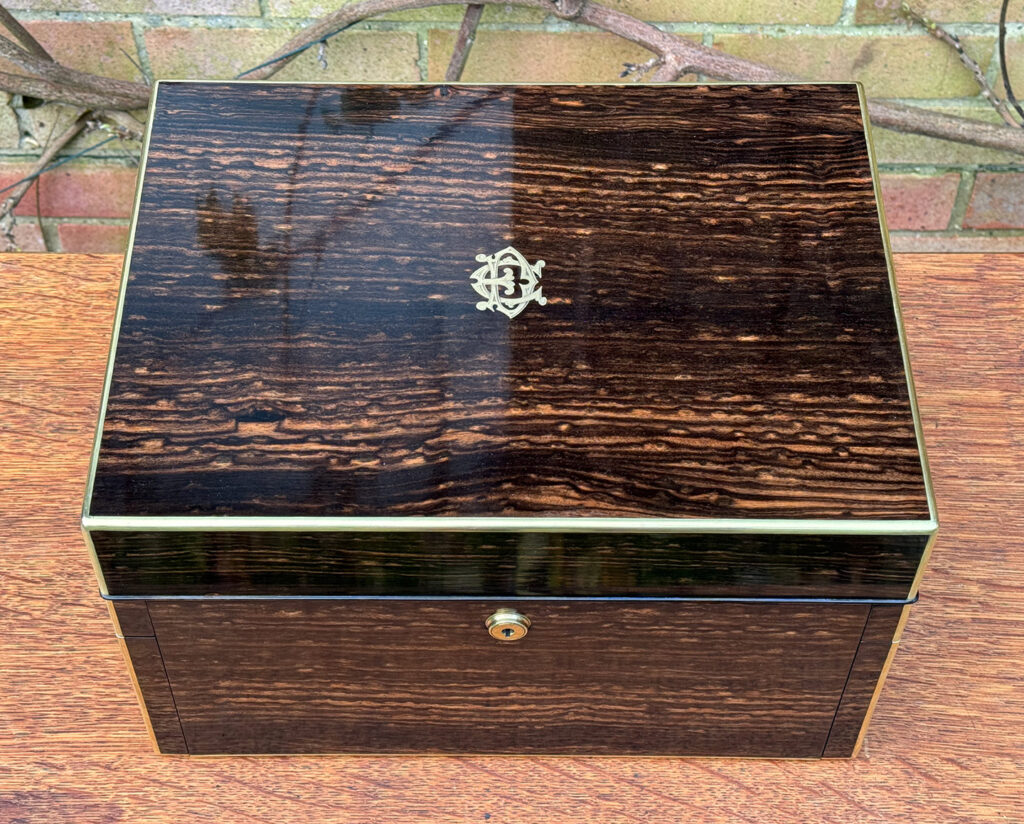 Top view of an Antique Jewellery Box in Coromandel with Betjemann Patent Automatic Mechanism, by Fisher.