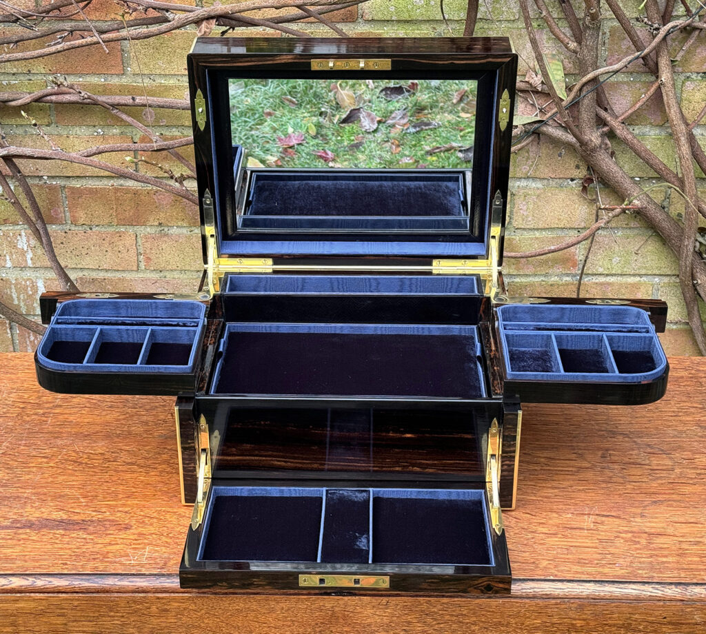 Front internal view of an Antique Jewellery Box in Coromandel with Betjemann Patent Automatic Mechanism, by Fisher with mirror frame displayed.