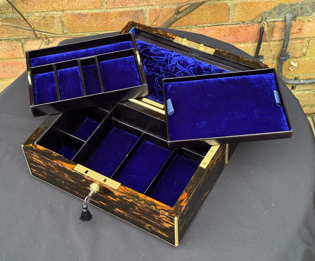 Overhead internal view of an Antique 180-Degree Opening Travelling Jewellery Box in Coromandel with trays removed.