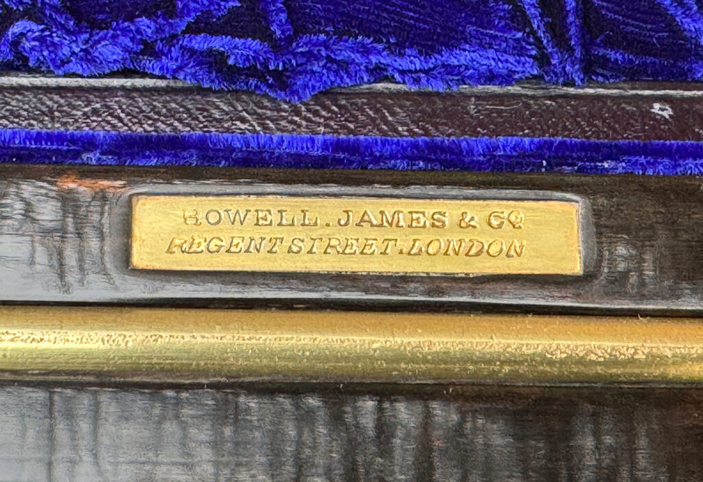 Close up of makers plate from an Antique 180-Degree Opening Travelling Jewellery Box in Coromandel.