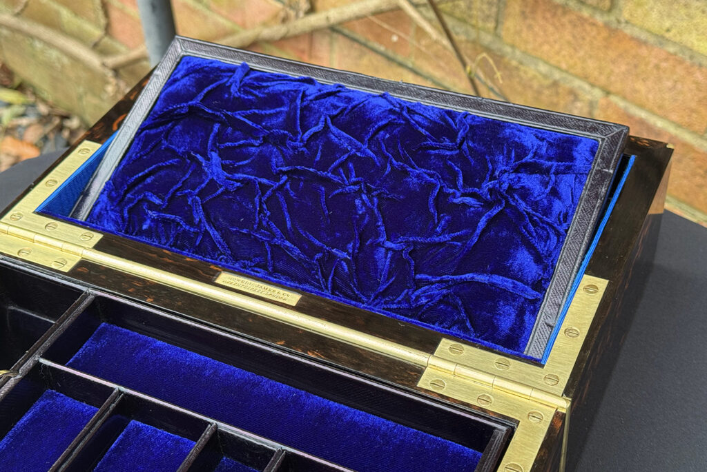 Close up of mirror panel raised from an Antique 180-Degree Opening Travelling Jewellery Box in Coromandel.