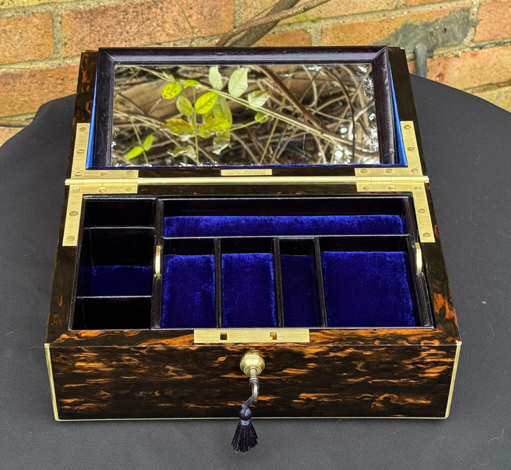 Overhead internal view of an Antique 180-Degree Opening Travelling Jewellery Box in Coromandel with mirror raised.