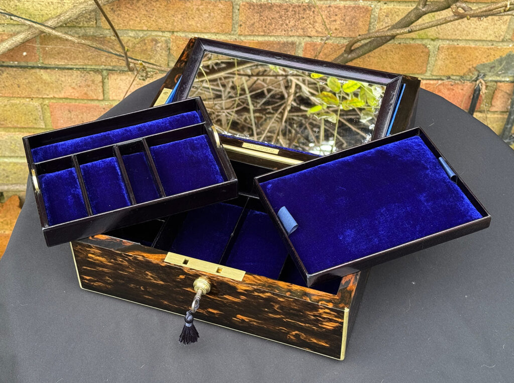 Overhead internal view of an Antique 180-Degree Opening Travelling Jewellery Box in Coromandel with trays removed and mirror raised.