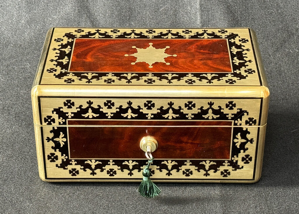 Front view of an Antique Miniature Jewellery Box in Flame Mahogany with Brass & Ebony Inlay.