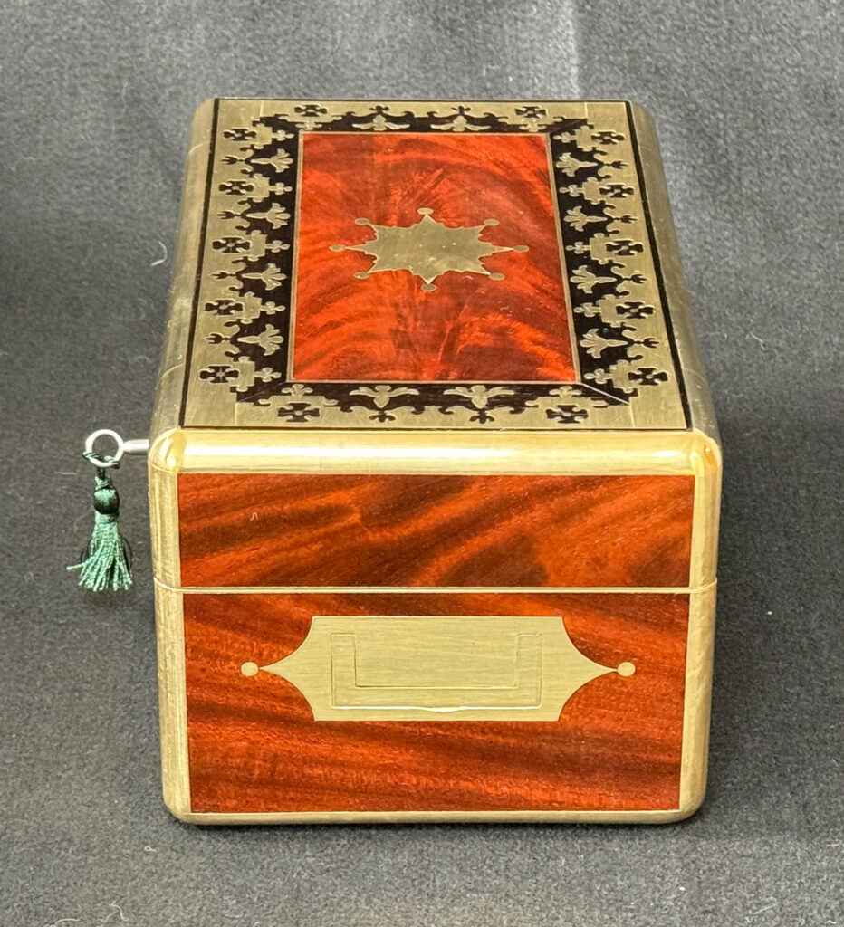 Right side view of an Antique Miniature Jewellery Box in Flame Mahogany with Brass & Ebony Inlay.