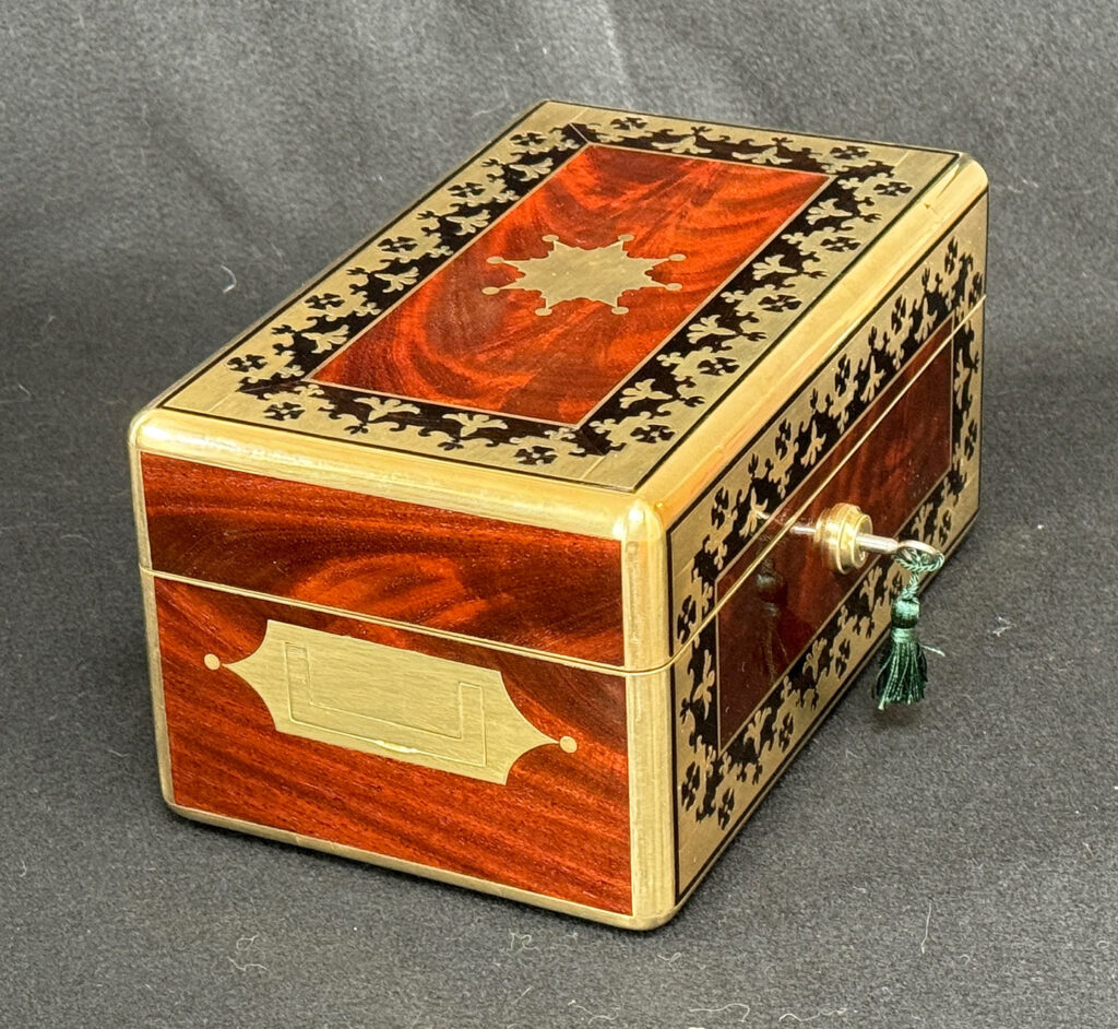 Left side view of an Antique Miniature Jewellery Box in Flame Mahogany with Brass & Ebony Inlay.