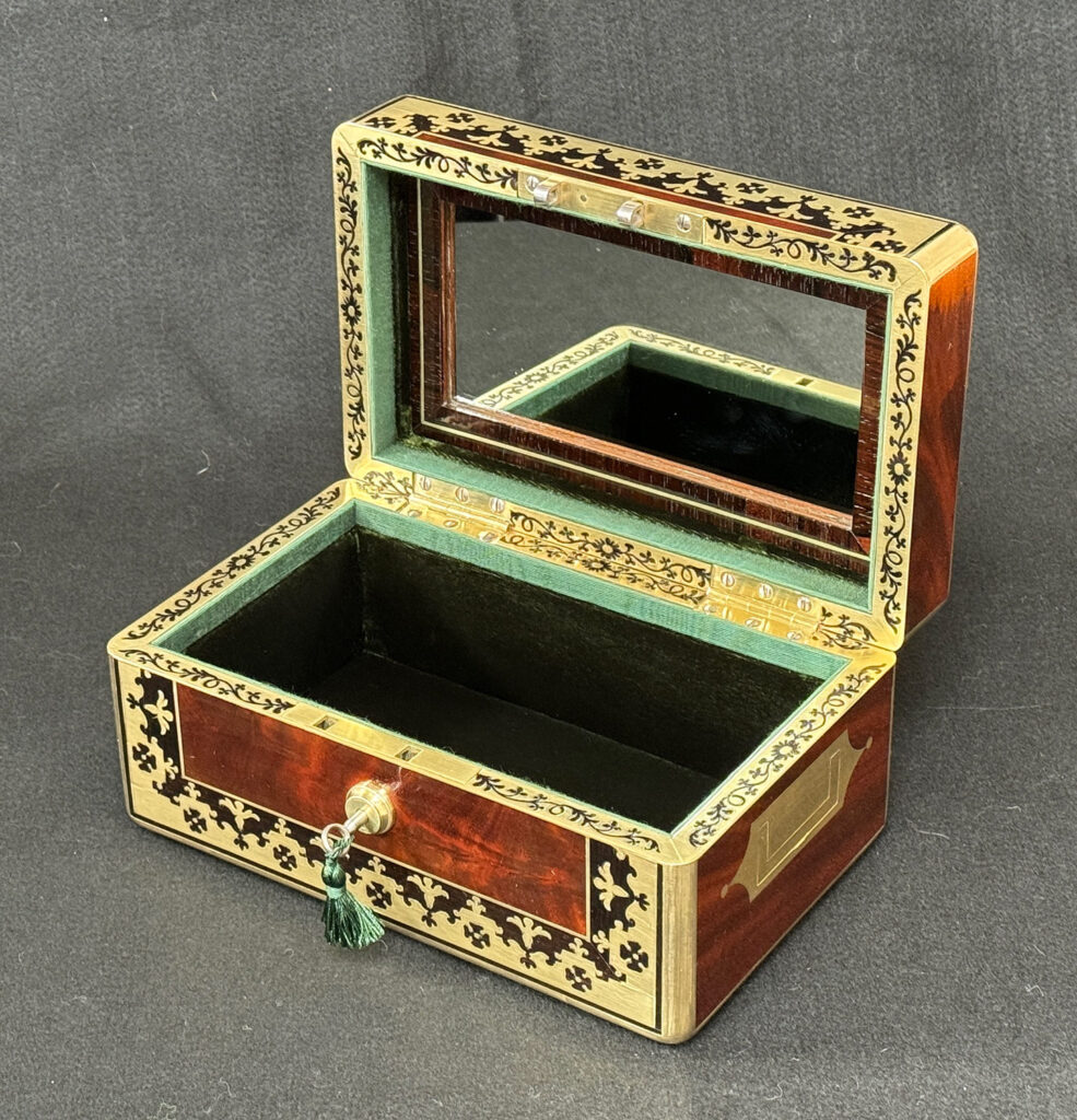 Front right internal view of an Antique Miniature Jewellery Box in Flame Mahogany with Brass & Ebony Inlay.