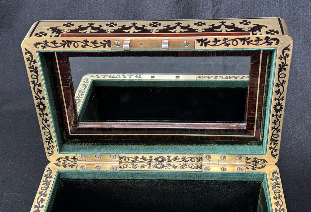 Close up of mirror panel from an Antique Miniature Jewellery Box in Flame Mahogany with Brass & Ebony Inlay.