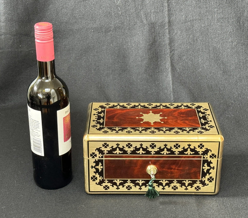 Size comparison of an Antique Miniature Jewellery Box in Flame Mahogany with Brass & Ebony Inlay.