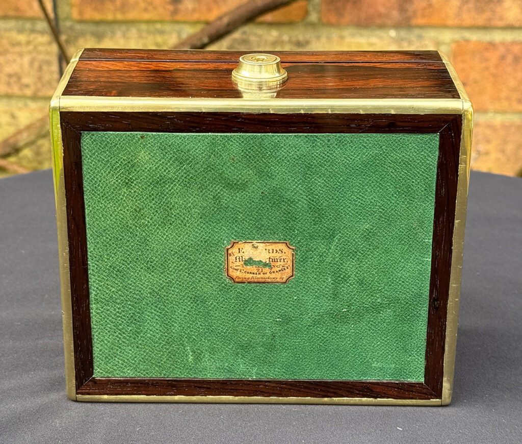 View of the paper makers label from a Miniature Antique Jewellery Box in Rosewood, by Edwards.