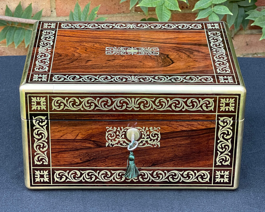 Front view of an Antique Jewellery Box in Rosewood with Scrollwork Brass Inlay.