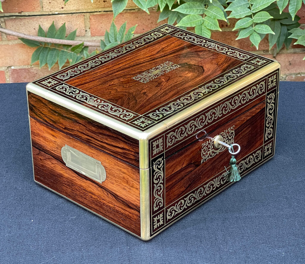 Front left view of an Antique Jewellery Box in Rosewood with Scrollwork Brass Inlay.