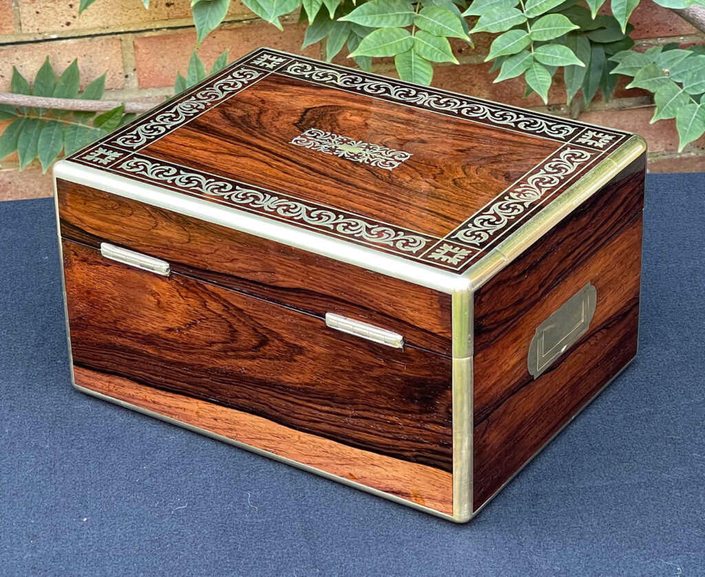 Rear left view of an Antique Jewellery Box in Rosewood with Scrollwork Brass Inlay.